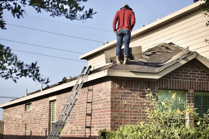 Professional roofer working on a residential roof in Gannett Corners